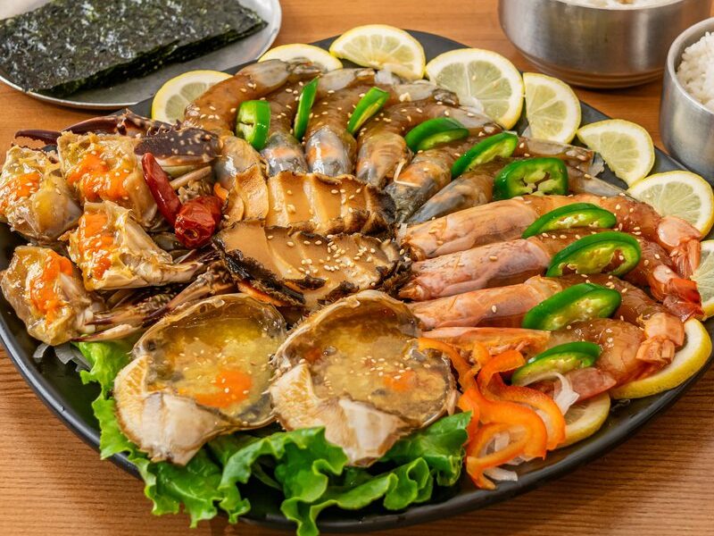 Soy-marinated crab, shrimp and abalone platter with lemon, jalapeño, rice and seaweed